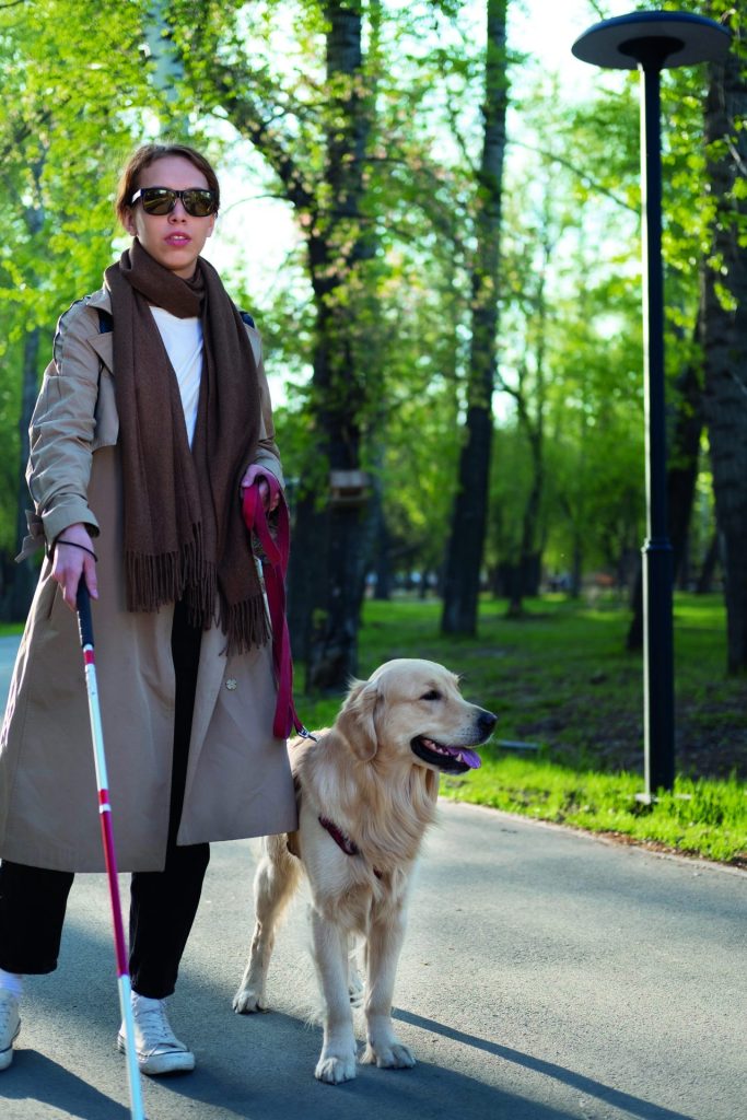 full-shot-woman-walking-with-dog-cane